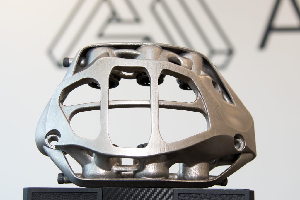A 3D printed automotive part. The component looks like it would fit as part of a vehicle engine.